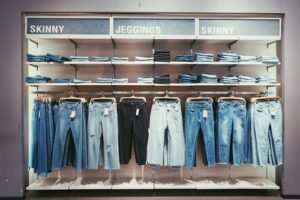 jeans hanging in store as feature image for apparel industry blog