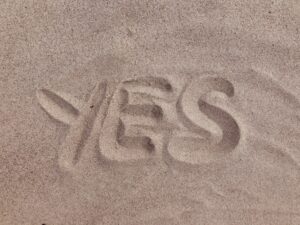 qualify for factoring blog feature image - word yes written in sand