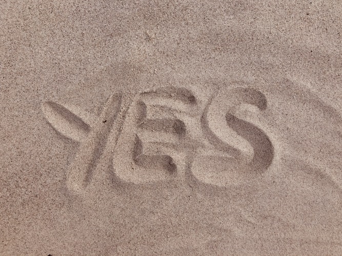 qualify for factoring blog feature image - word yes written in sand