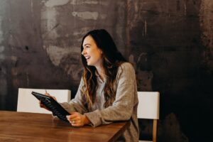 young-female-interviewing-at-desk-smiling