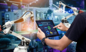 smart manufacturing blog feature image - man using tech in factory