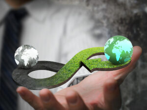 man-blurred-in background-hand-out-holding-two earths-going-round-in-circles