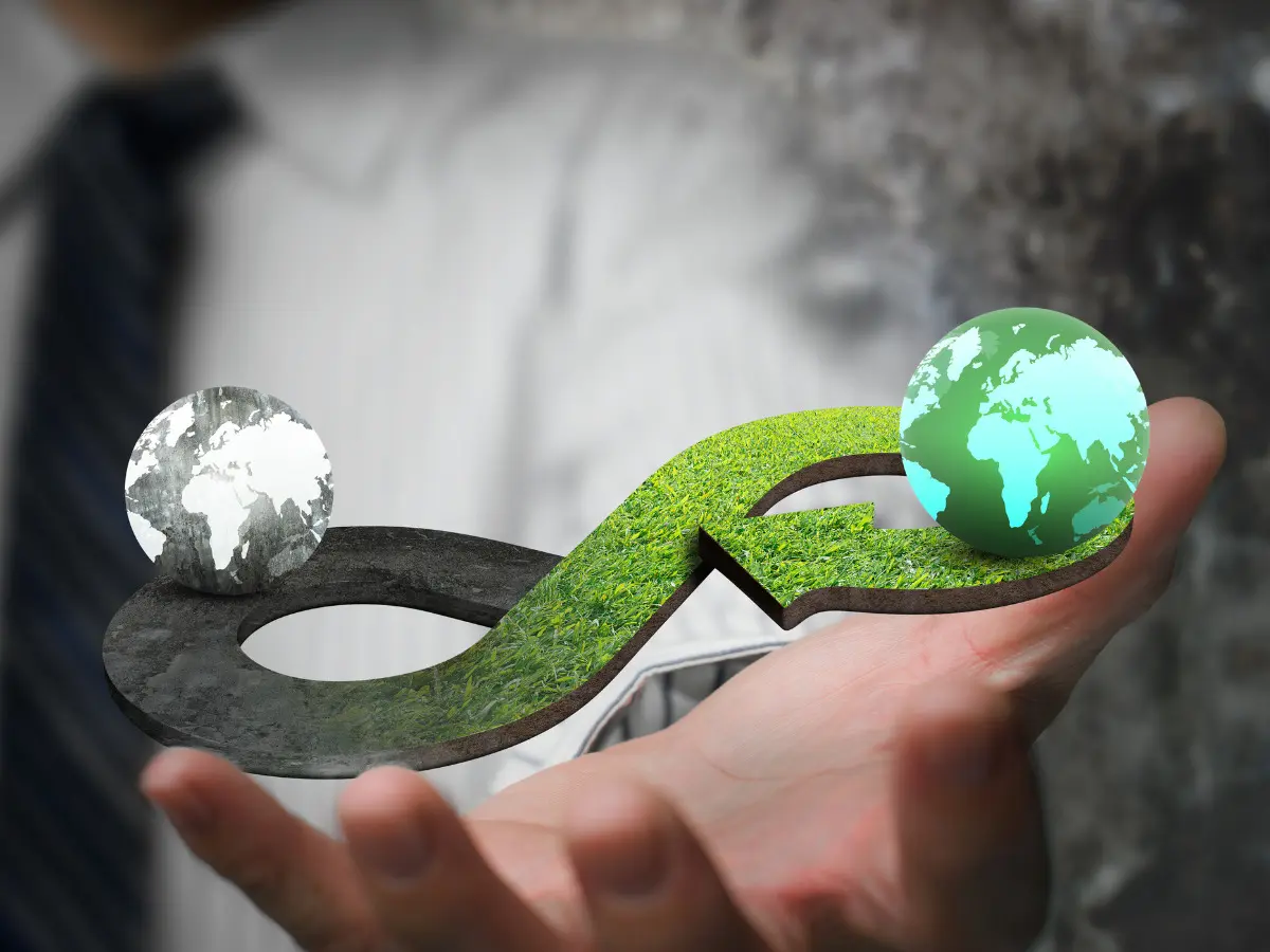 man-blurred-in background-hand-out-holding-two earths-going-round-in-circles